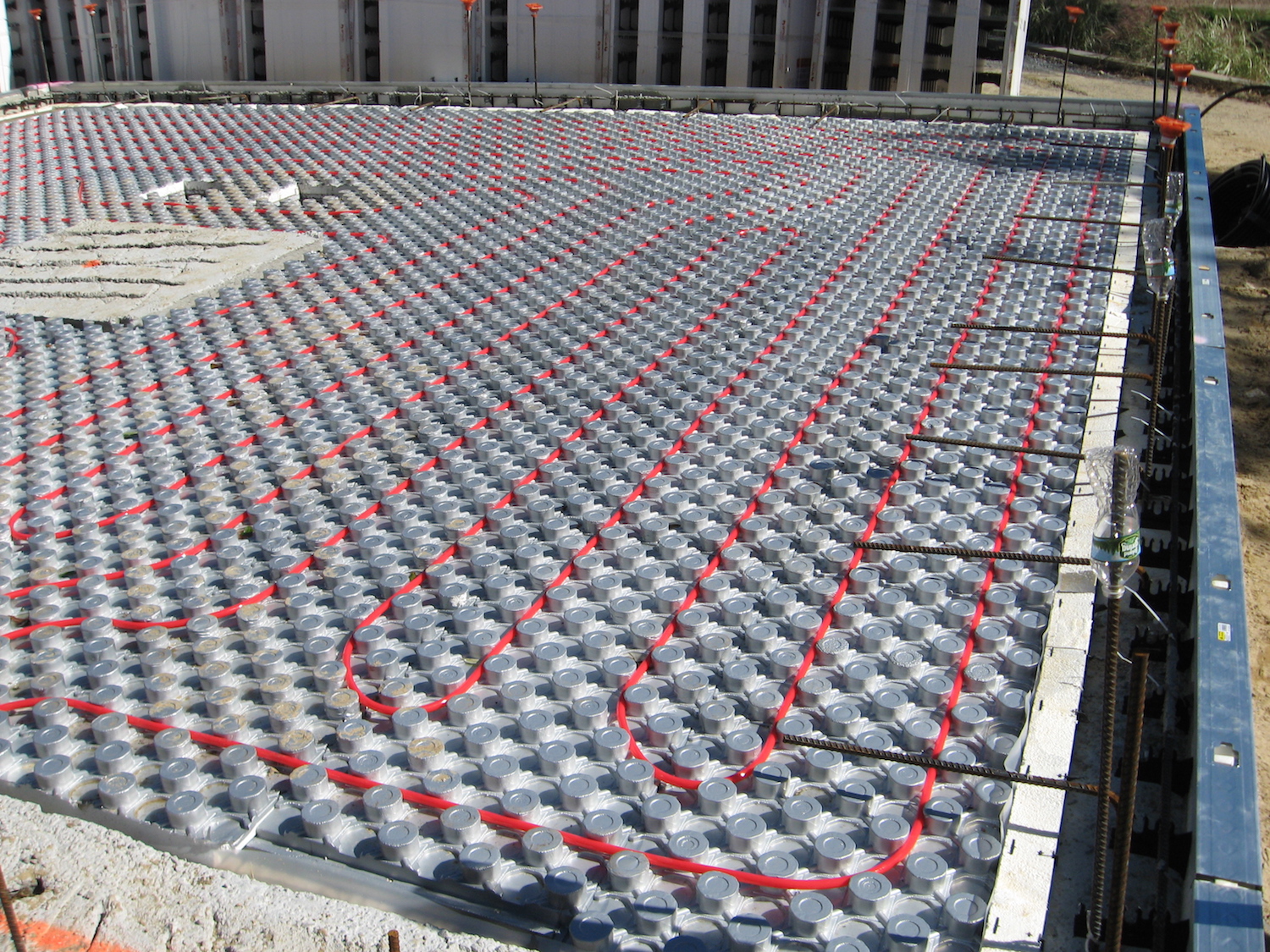 The ground floor of a new ICF home is seen with radiant heating carefully installed in the floor grid.