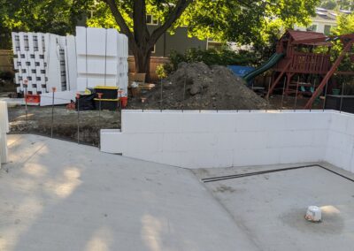 the first forms are laid out for an ICF pool with the bottom layer of concrete already dried.