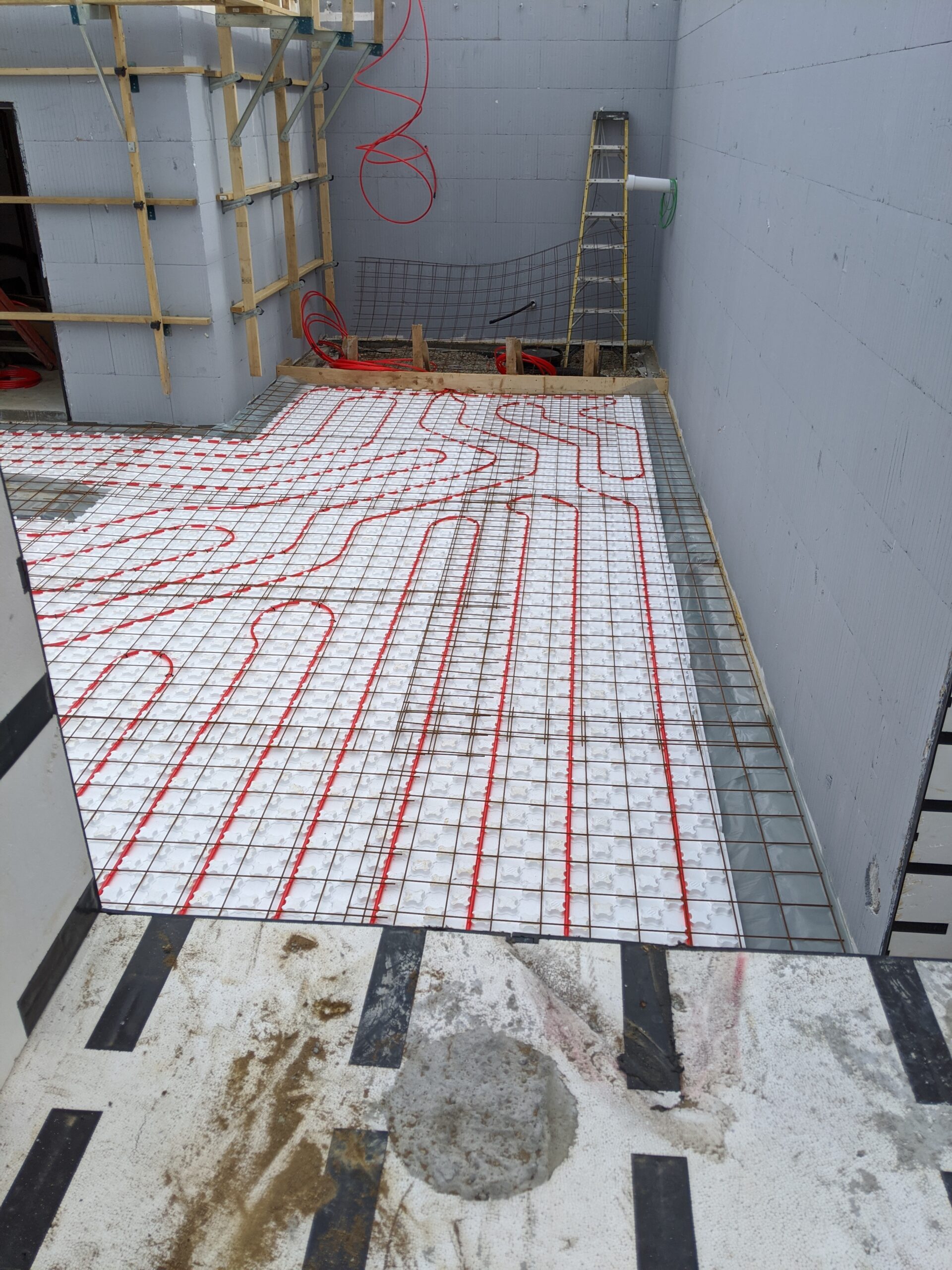 Radiant Floor heating as seen from a window view of an ICF Basement Foundation