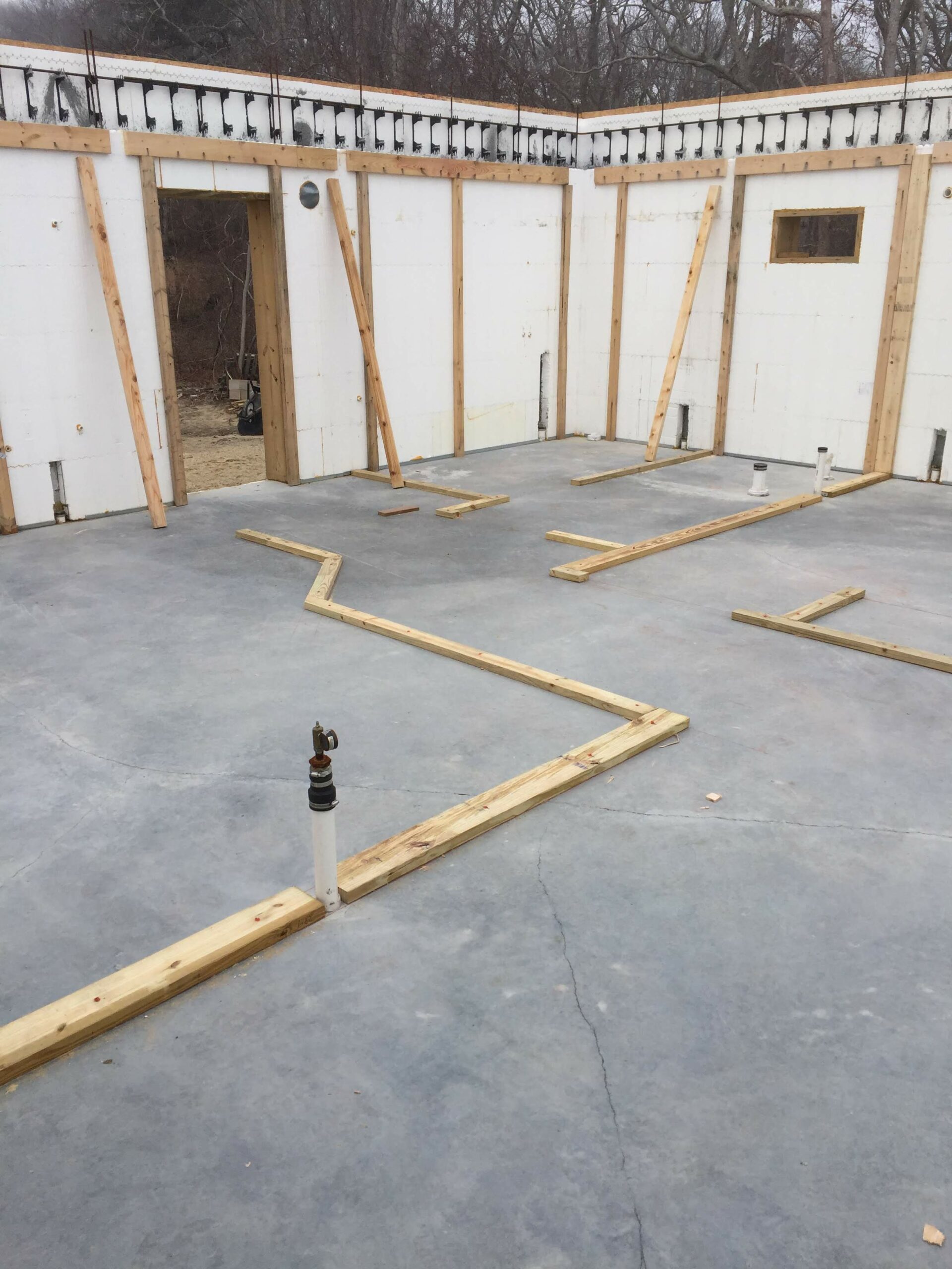 the base layer of wooden framing inside an ICF home is set ready for the interior wall framing to be built in this ICF home.